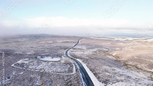 Aerial view of snowy landscape with winding road in the serene Lammermuirs, East Lothian, United Kingdom. photo