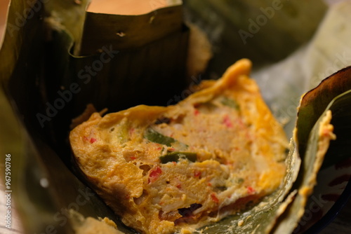 Spicy egg tofu pepes, wrapped in banana leaves. Indonesian cuisine. Pepes tahu telur. photo