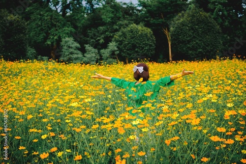 Scenic view of a field of vibrant yellow flowers with a person in the distance photo