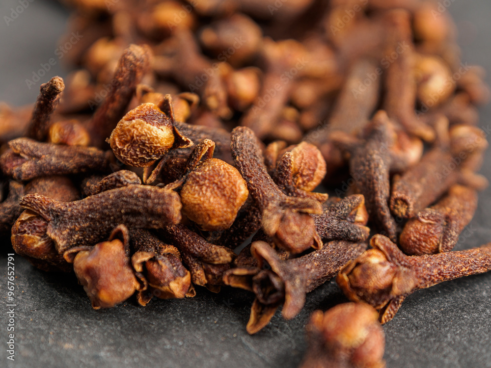 A close-up of aromatic cloves, highlighting the texture and rich color A close-up of aromatic cloves, highlighting the texture and rich color
