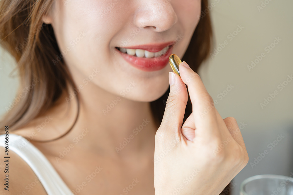 Nourishing the Body, Embracing Wellness: A Person Taking Fish Oil Supplements for Optimal Health and Vitality Nourishing the Body, Embracing Wellness: A Person Taking Fish Oil Supplements for Optimal Health and Vitality
