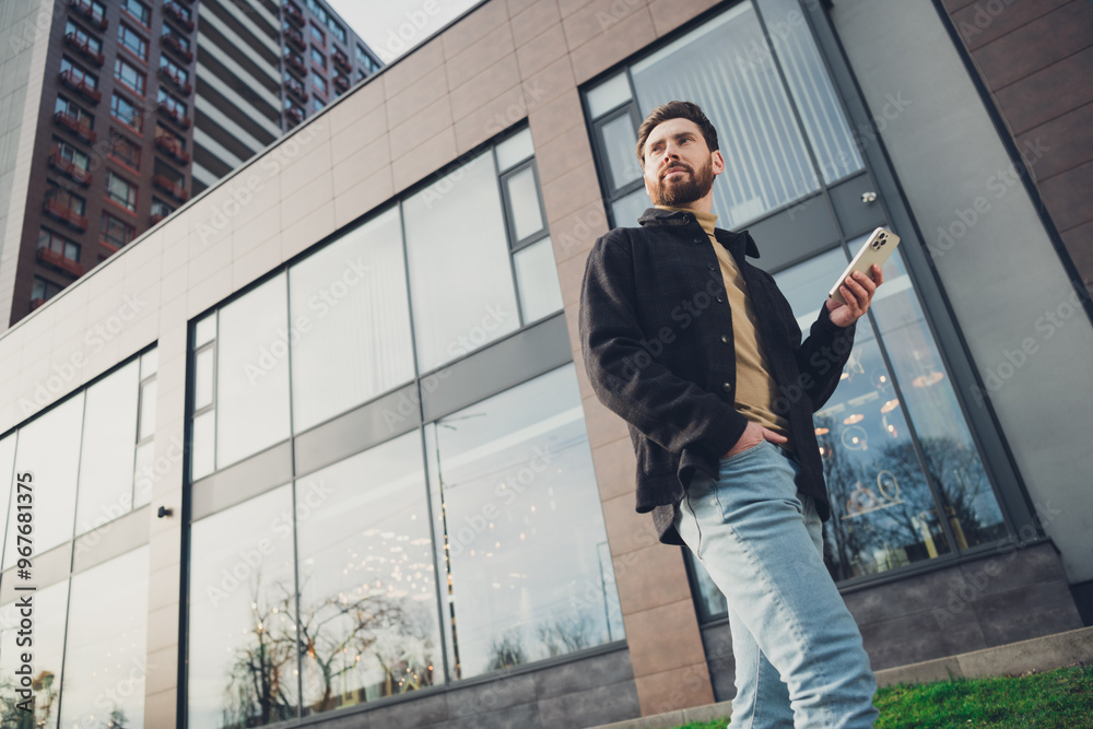 Photo of attractive stylish man wear trendy clothes walk alone city street autumn day outside hold gadget Photo of attractive stylish man wear trendy clothes walk alone city street autumn day outside hold gadget