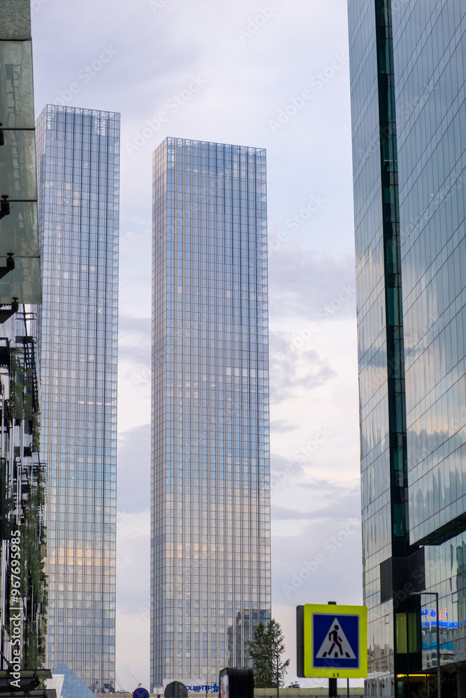 Modern Moscow City towers against a blue sky. Tall glass skyscrapers with mirror Modern Moscow City towers against a blue sky. Tall glass skyscrapers with mirror