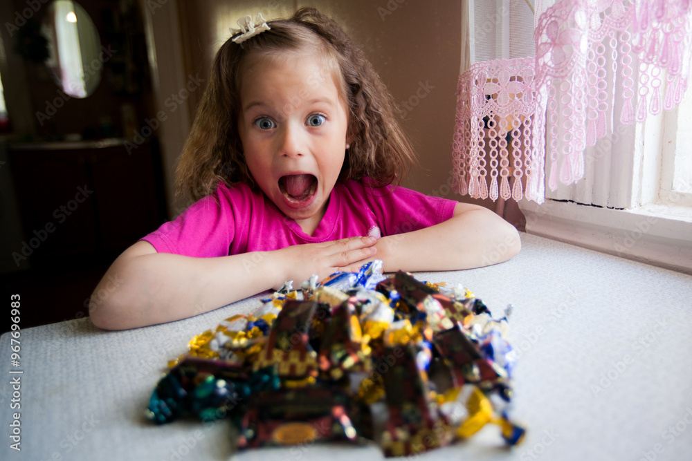 A little girl in shock wide eyed and open mouthed as she stares at a