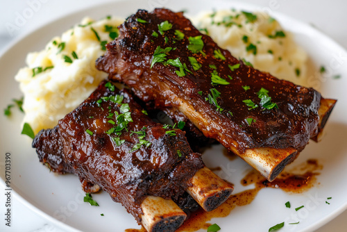 A Beautiful plate of meat cooked with vegetable sides and seasoned with herbs and spices on a white plate with natural daytime sunlight from the background shining on it