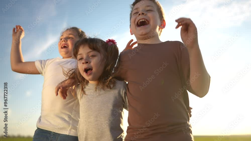 group of kids team hugging a jumping and rejoicing outdoors. happy family teamwork kid dream concept. family children sisters brothers have fun hugging sun in the park in nature group of kids team hugging a jumping and rejoicing outdoors. happy family teamwork kid dream concept. family children sisters brothers have fun hugging sun in the park in nature
