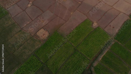 Aerial view of serene countryside farmland with patchwork fields at sunset, Thakhek, Laos. photo