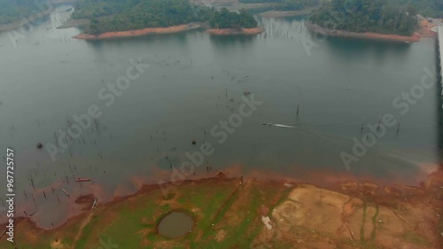 Aerial view of a serene river with a winding bridge and a motorbike, Nam Theun, Laos. photo