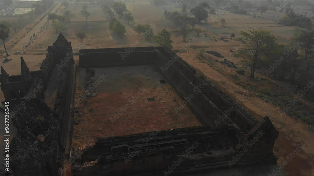 Aerial view of ancient Khmer temple ruins amidst lush landscape at sunrise, Wat Phou, Laos. Aerial view of ancient Khmer temple ruins amidst lush landscape at sunrise, Wat Phou, Laos.