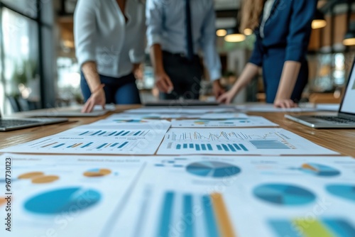 Wallpaper Mural Team of professionals analyzing a business plan in a modern office setting, teamwork and collaboration concept.  Torontodigital.ca