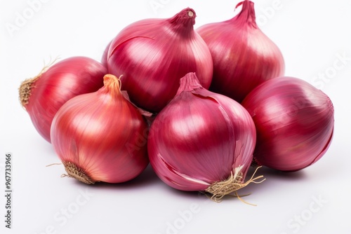 Fresh red onions piled together on a white surface showcasing their vibrant color and texture