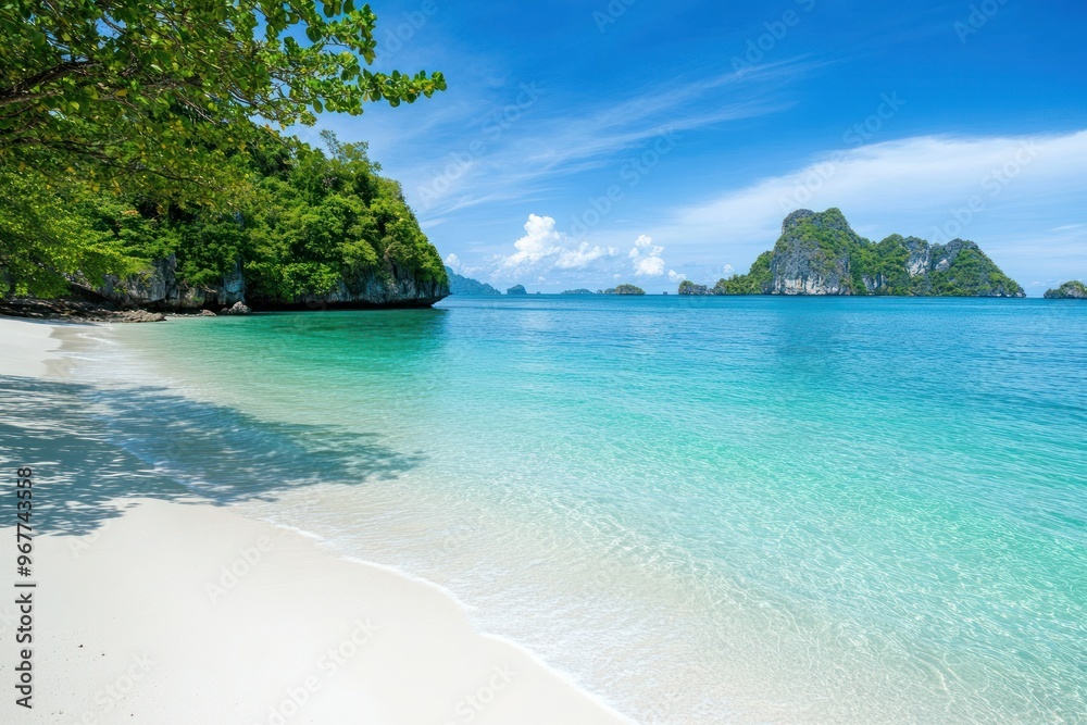 Fototapeta premium Scenic tropical beach with crystal clear blue waters and white sandy shores.