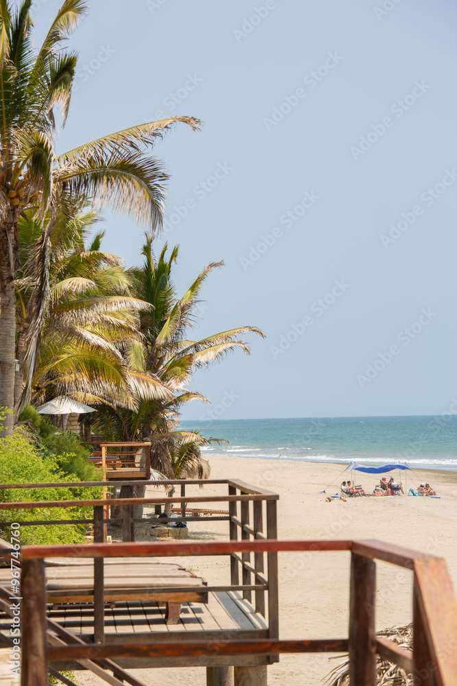 Tropical beach with palm trees and wooden walkway, Mancora Piura Peru Tropical beach with palm trees and wooden walkway, Mancora Piura Peru