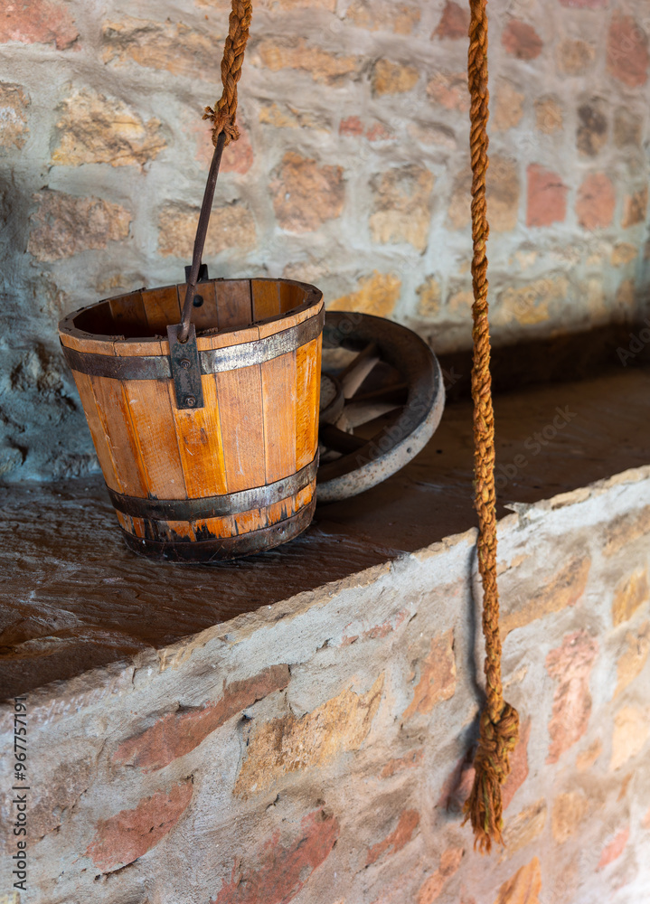 wooden bucket with a rope hanging from it wooden bucket with a rope hanging from it