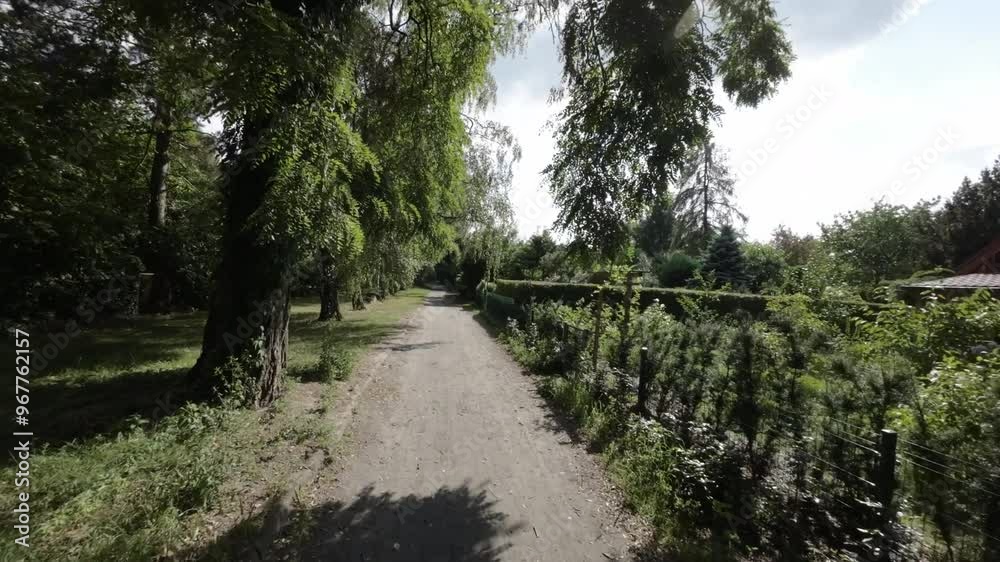 Immerse yourself in the tranquility of a charming neighborhood with our captivating video. The camera takes you on a smooth journey along a tree-lined path, where youll witness the harmonious Immerse yourself in the tranquility of a charming neighborhood with our captivating video. The camera takes you on a smooth journey along a tree-lined path, where youll witness the harmonious