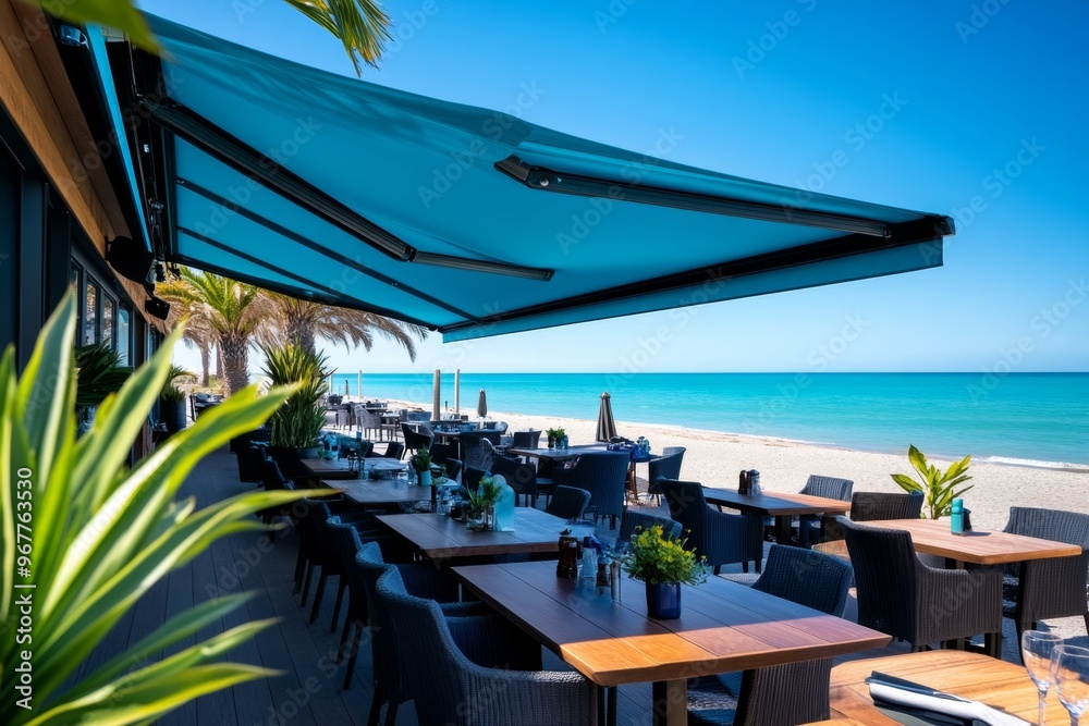 Fototapeta premium A vibrant blue awning at a seaside cafÃ©, shading customers from the sun while offering views of the ocean