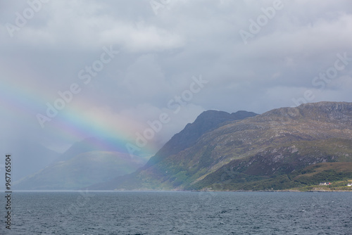 Scottish coastline during a storm, Image shows the large hills along the Scottish coast during a heavy rainfall showing a rainbow coming from the land