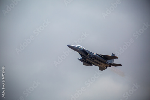 F15 fighter jet taking off with landing gear up, from a public road