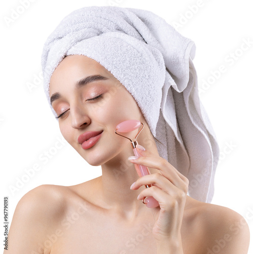 Beautiful girl with thick eyebrows and perfect skin at white background, towel on head, beauty photo. Holds a cosmetic roller.
