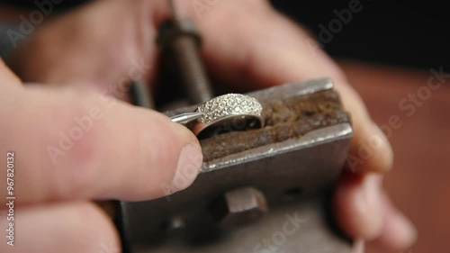 A man creates a piece of jewelry. photo