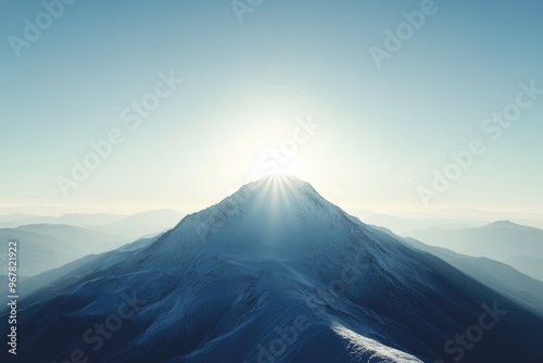 Snow-covered mountain peak at sunrise with long shadow, clear skies