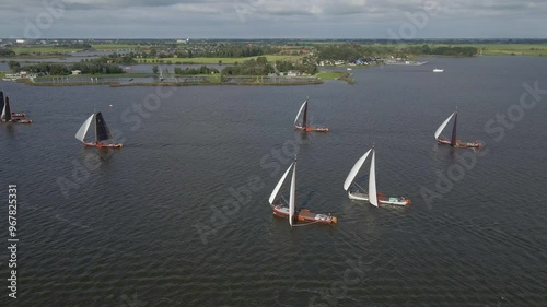 Aerial view of sailboats competing in a regatta on the serene Sneekermeer lake, Sneek, Netherlands. photo