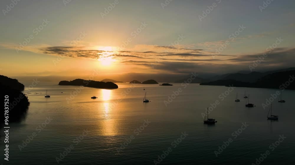 Aerial view of tropical islands at sunset with serene ocean and sailing boats, Brazilian coast, Brazil. Aerial view of tropical islands at sunset with serene ocean and sailing boats, Brazilian coast, Brazil.