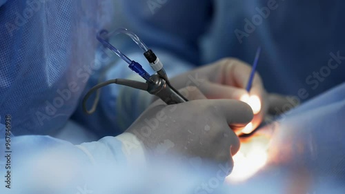Wallpaper Mural A doctor uses a metal instrument in surgery. Torontodigital.ca