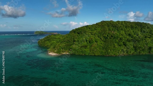Aerial view of a tropical island with lush greenery and pristine blue waters, Atua, Samoa. photo