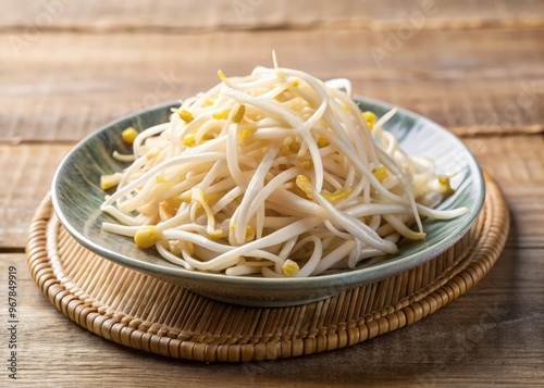 Freshly steamed bean sprouts, glistening with moisture, arranged artfully on a small, creamy ceramic plate, captured with a shallow depth of field to emphasize the tender, crunchy texture.