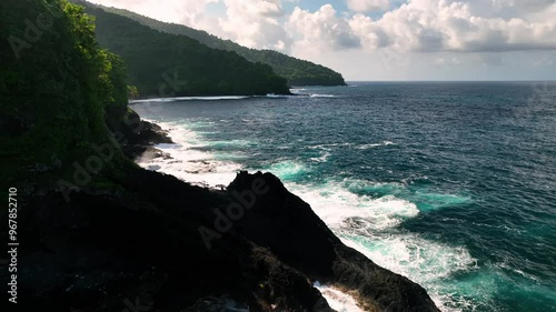 Aerial view of tropical island coastline with lush greenery and rocky cliffs, Atua, Samoa. photo