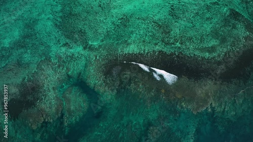 Aerial view of beautiful ocean and vibrant reef with tranquil waves, Tuamasaga, Samoa. photo