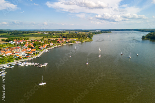 Drone shot of Mikołajki in summer, featuring a boat on the lake amidst the lush Masurian landscape. photo