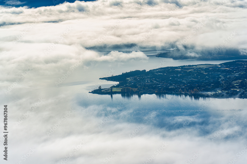 Scenic foggy mountain from summit of Roys Peak with Lake Wanaka in the morning at New Zealand Scenic foggy mountain from summit of Roys Peak with Lake Wanaka in the morning at New Zealand