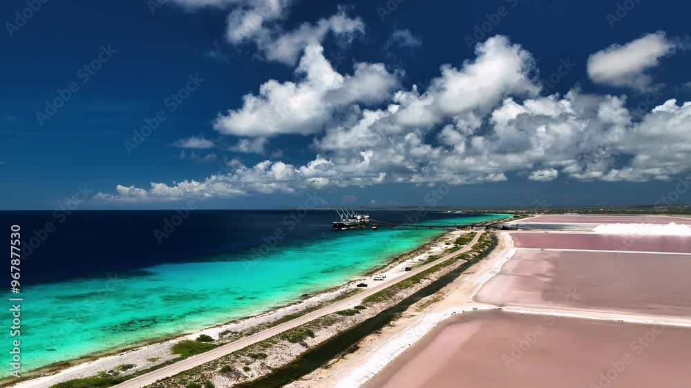 Aerial view of pink salt flats beside the turquoise ocean and serene coastline, Caribbean, Netherlands. Aerial view of pink salt flats beside the turquoise ocean and serene coastline, Caribbean, Netherlands.