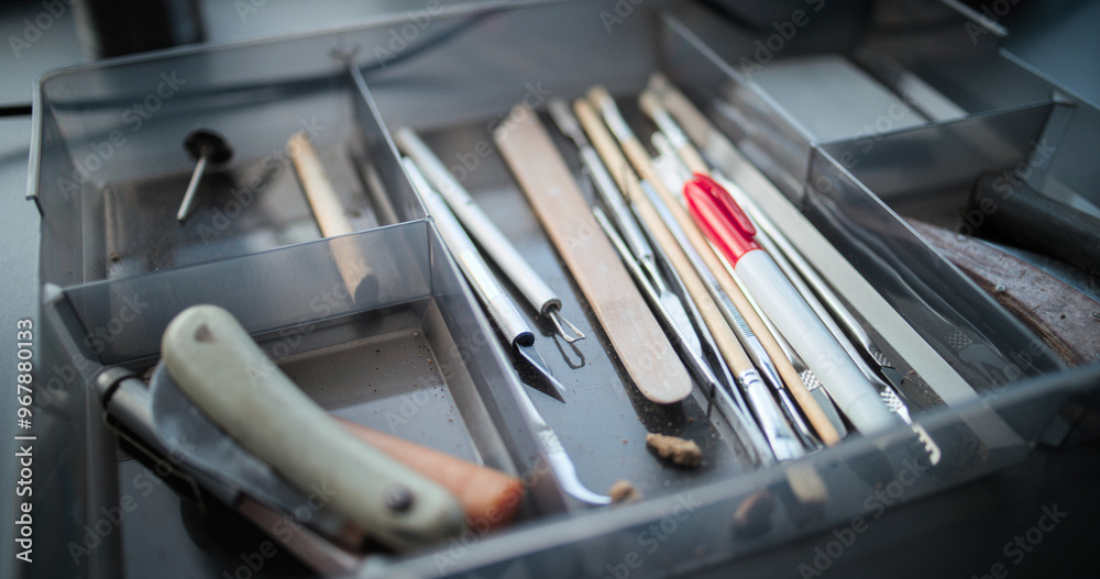Close up shot of professional tools for cleaning and studying fossils lying in the box. Equipment in modern and advanced archaeological scientific lab. Concept of archaeology and science. Handheld. Close up shot of professional tools for cleaning and studying fossils lying in the box. Equipment in modern and advanced archaeological scientific lab. Concept of archaeology and science. Handheld.
