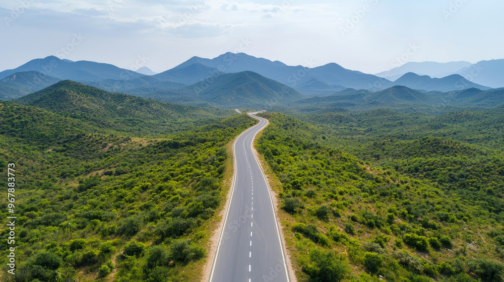 A scenic winding road through lush green hills and mountains, perfect for travel and adventure enthusiasts seeking natural beauty. A scenic winding road through lush green hills and mountains, perfect for travel and adventure enthusiasts seeking natural beauty.