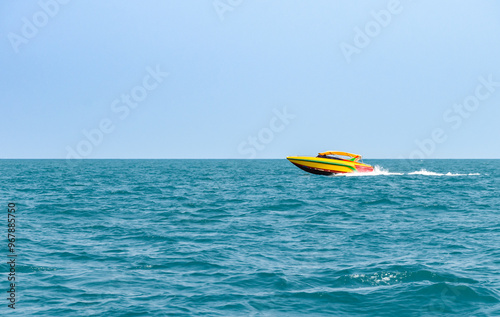 Speedboat sailing on the blue tropical sea on the background clear blue sky morning day at Koh Larn island. Speed boat running on the bay, Panorama ocean, Pattaya, Thailand, Vacation.