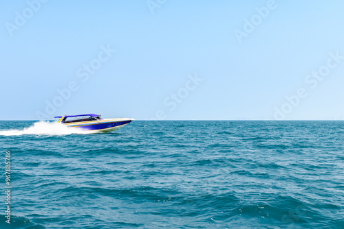 Speedboat sailing on the blue tropical sea on the background clear blue sky morning day at Koh Larn island. Speed boat running on the bay, Panorama ocean, Pattaya, Thailand, Vacation.