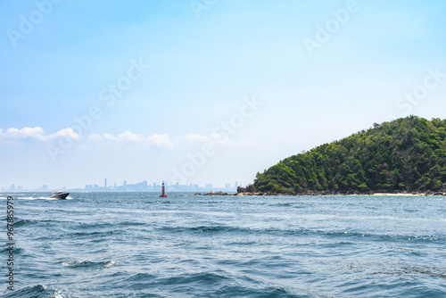 Landscape of island and tropical beach morning day at Koh Larn island on blue sea and blue clear sky background. Pattaya, Thailand. Wave, Speed boat, Ferry ship, Seascape, Vacation, Summer, Holiday.