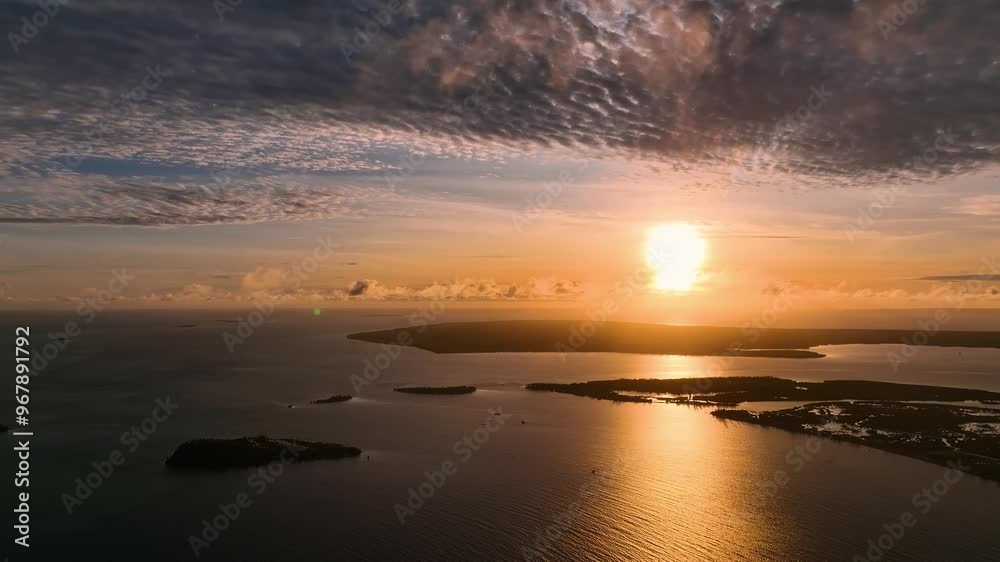 Aerial view of serene sunrise over the ocean with islands and clouds, Tongatapu, Tonga. Aerial view of serene sunrise over the ocean with islands and clouds, Tongatapu, Tonga.