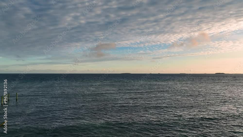 Aerial view of tranquil reef and calm ocean under a beautiful sunset with clouds, Tonga. Aerial view of tranquil reef and calm ocean under a beautiful sunset with clouds, Tonga.