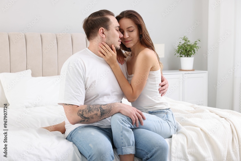 Cute couple spending time together on bed at home Cute couple spending time together on bed at home