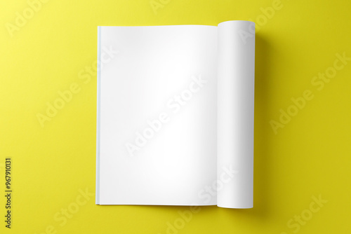 Open magazine on yellow background, top view. Mockup for design