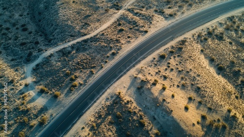 Aerial view of a winding road through arid terrain, showcasing natural landscape patterns.
