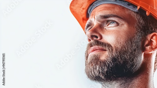 Portrait of a man in a hard hat, looking up with determination and focus, symbolizing safety and professionalism in construction. photo