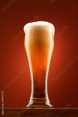 a glass of beer, a wooden stand, a red background, a close-up view of the object, beer bubbles and foam