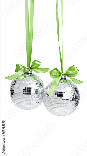 Two silver disco balls hanging from green ribbons photo