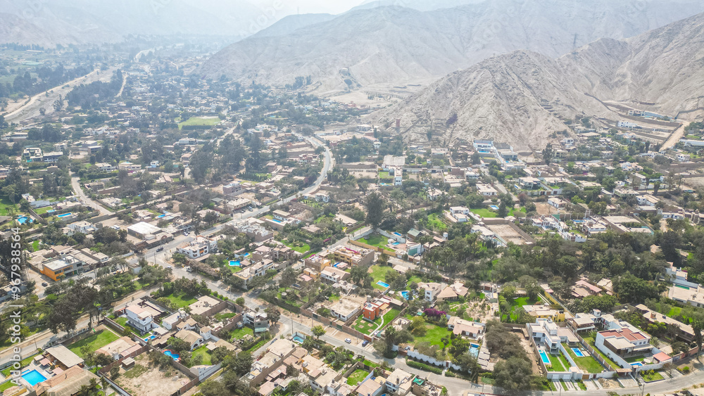 South American suburban landscape in a desertic valley surrounded by mountains during the afternoon taken from drone South American suburban landscape in a desertic valley surrounded by mountains during the afternoon taken from drone
