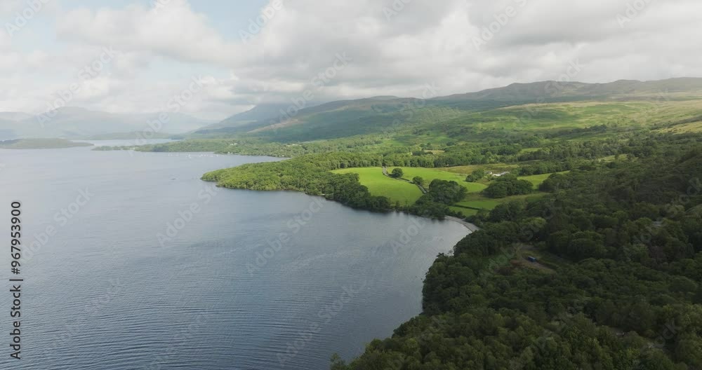 Aerial view of serene Loch Lomond surrounded by lush forests and hills under a picturesque sky, Balmaha, Scotland. Aerial view of serene Loch Lomond surrounded by lush forests and hills under a picturesque sky, Balmaha, Scotland.